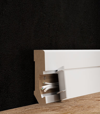 A lifestyle image of the Vox Estilo skirting board E301 in colour white. Demonstrates cables that can be hidden inside the skirting board. 