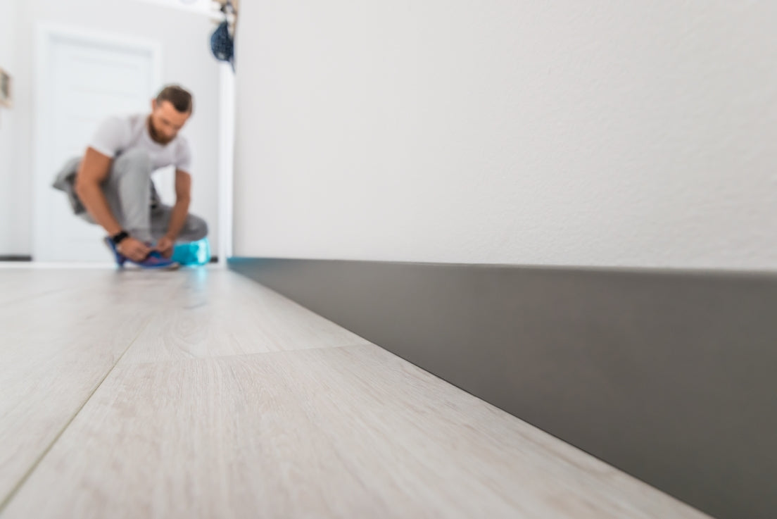 A lifestyle image of the Vox Evera skirting board in colour dark grey.